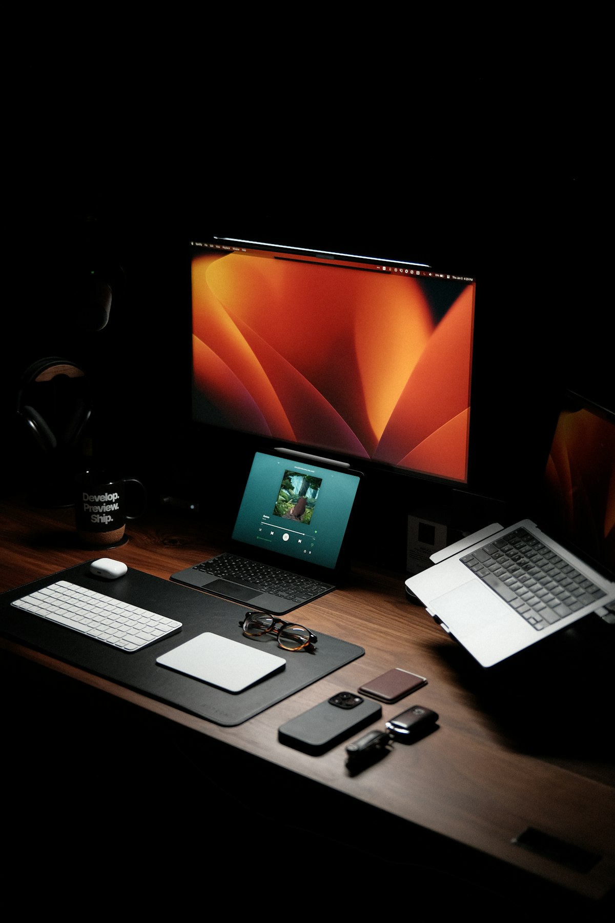 A tidy desk with a laptop next to a monitor